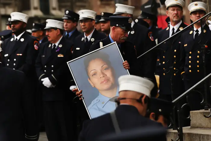 A picture of New York City fire department EMT Yadira Arroyo is brought into St. Nicholas of Tolentine R.C. Church in the Bronx during her funeral.